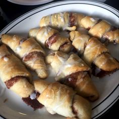 a white plate topped with pastries covered in icing