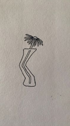 a drawing of a vase with a flower in it's center and a line drawn on the paper