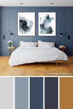 a bedroom with blue walls and wooden floors, two pictures on the wall above the bed