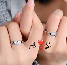 two hands with rings on each finger and the word as above them, in front of a woman's face