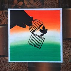 a painting of a bird in a cage being fed by a person's hand