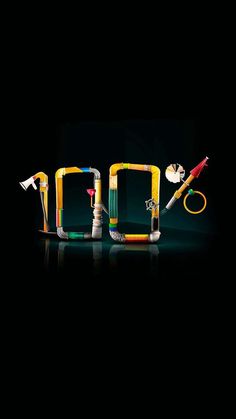 an assortment of toothbrushes arranged in the shape of letters on a black background