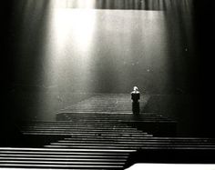 a person standing in front of a stage with spotlights