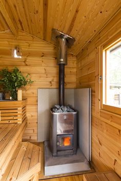 a wood burning stove inside of a wooden cabin