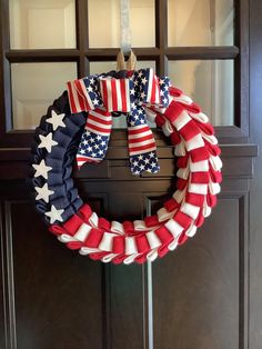 an american flag wreath hangs on the front door