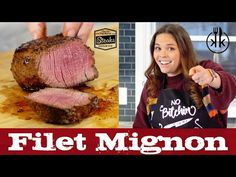 a woman holding a knife over a piece of meat