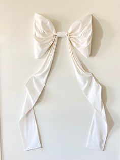 a white bow hanging on the wall