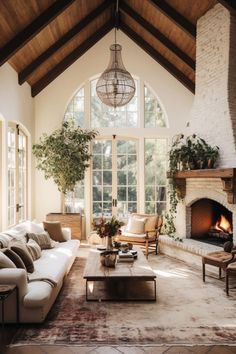 a living room filled with furniture and a fire place in front of a large window