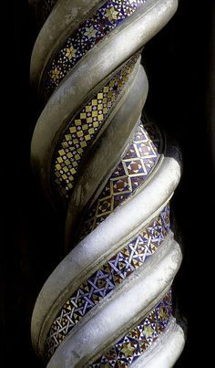 an intricately designed vase sitting on top of a table