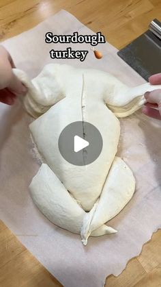 someone is making a turkey out of dough on a piece of paper with the words sourdough turkey