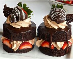 three chocolate cakes with strawberries on top