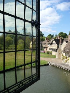 the view from an open window looking at houses and water