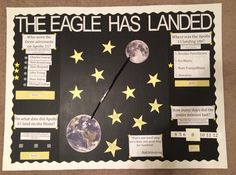 a bulletin board with stars and the earth on it that says the eagle has landed