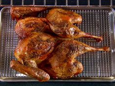 a bunch of chicken sitting on top of a metal pan in an oven with rack