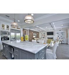 a large kitchen with an island in the middle and lots of counter space around it