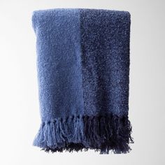 a blue towel hanging from a hook on a wall