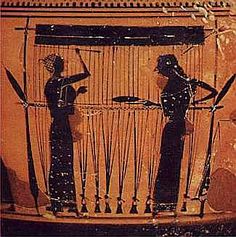 two people standing next to each other in front of an ancient vase