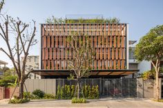 the building has wooden slats on it's sides and is surrounded by trees