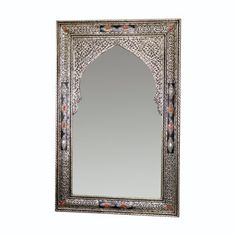 an ornate mirror on a white wall