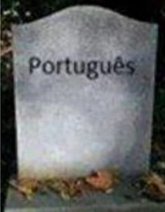 a headstone with the word portugals on it in front of some grass and bushes