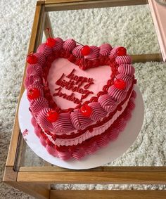 a heart shaped cake sitting on top of a table