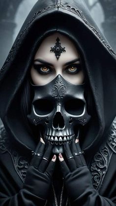 a woman in black is holding her hands to her face while wearing a skull mask