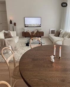 a living room filled with furniture and a flat screen tv mounted to the side of a wall