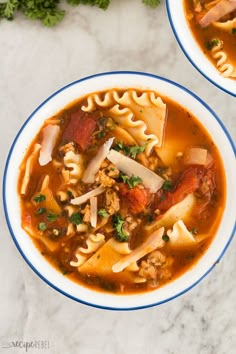 two bowls of soup with noodles, meat and vegetables