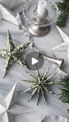 paper stars and candles on a marble table