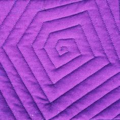 a purple quilt with an intricate design on it