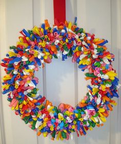 a colorful wreath is hanging on the front door