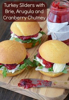 three turkey sliders with brie, arugula and cranberry chutney