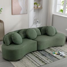 a large green couch sitting on top of a rug