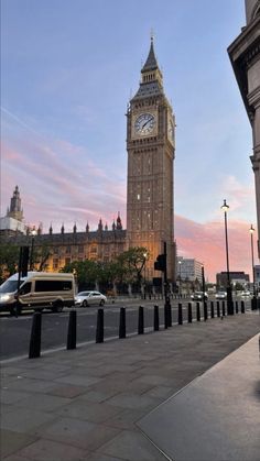 the big ben clock tower towering over the city of london, england at sunset or dawn