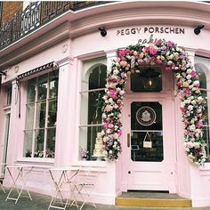 the front entrance to peggy porshen florist with pink and white flowers