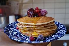 a stack of pancakes with fruit on top