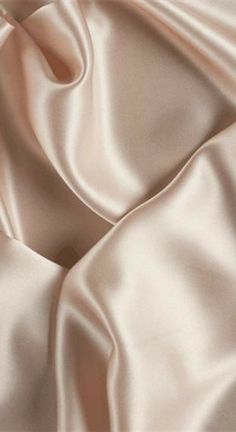 a close up view of a white satin fabric