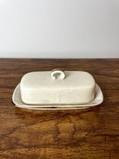 a wooden table with a white dish on it