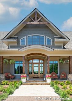 the front entrance to a large house with lots of windows