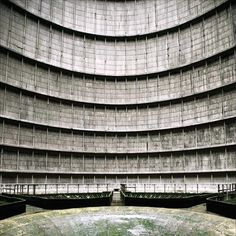 the inside of a large concrete structure with green moss growing on it's sides