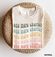 a t - shirt with the words one more charter on it sitting on a wicker basket