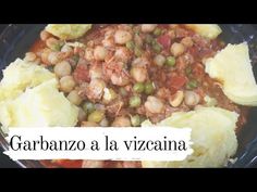 a bowl filled with beans and potatoes on top of a wooden table next to a sign that says garbanzo la vizzana