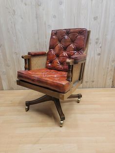 a brown leather chair sitting on top of a wooden floor