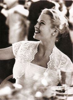 a black and white photo of a woman sitting at a table