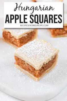 two pieces of apple squares with powdered sugar on top and the words, hungarian apple squares