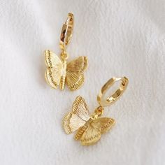 A Pair Of Dainty Butterfly Charms Hang From Small Huggie Hoop Earrings. We Love How Sweet And Delicate This Design Is. Details: Approx 11mm/.43in. Hoops Inner Diameter 9mm/.35in. Butterfly Approx 10mm/.39in. Lever Back Solid Brass 14k Gold Plated New With Tags Comes Gift Wrapped. May Vary Slightly From Photo. Deer Jewelry, Dainty Butterfly, Dainty Chain Necklace, Huggie Earrings Gold, Butterfly Earrings Gold, Earrings Butterfly, Bar Necklace Personalized, Jewelry Lookbook, Butterfly Jewelry