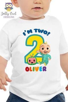 a baby wearing a t - shirt with the number two on it