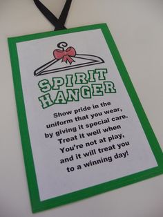 a green and white sign that says spirit hanger with a black ribbon around it