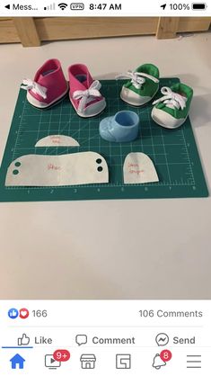 several pairs of shoes are sitting on a cutting board next to some scissors and tape