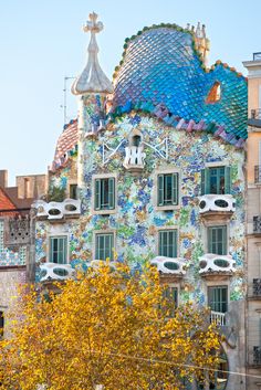 the colorful building has many windows and balconies on it's sides,